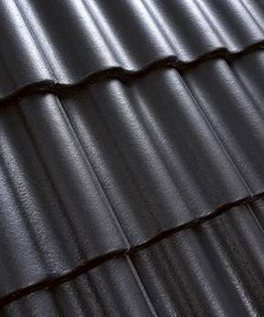 Närbild av en yta av ett tak med svarta takpannor i betong.